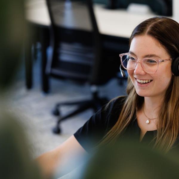 Woman with glasses talking on phone headset