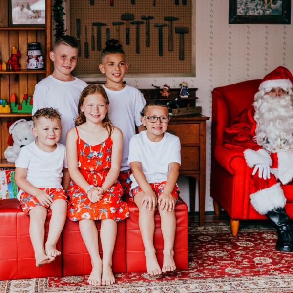 five children sitting with Santa for a Santa photo