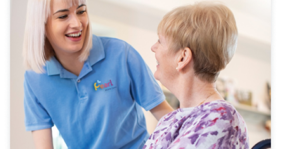 Pearl Home Care staff assisting woman in wheelchair