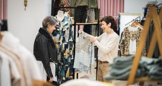 Two women shopping at in a clothing store