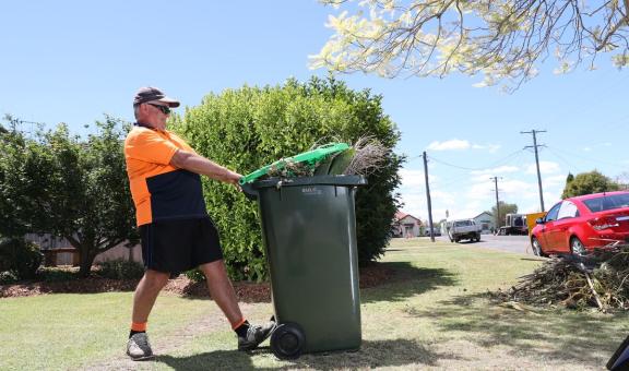 Man putting bin on kerbside in Maitland