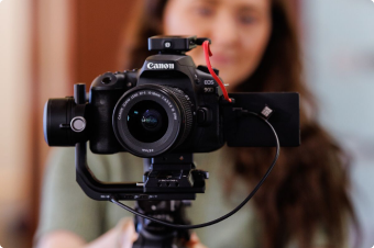 Woman standing behind a camera