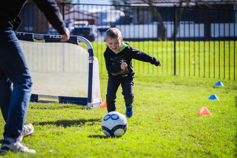 Young boy playing football