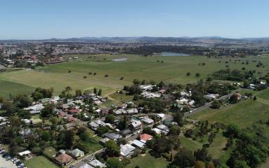 Wide aerial shot of Central Maitland looking out to farm land and housing