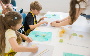 Children participating in a clay workshop