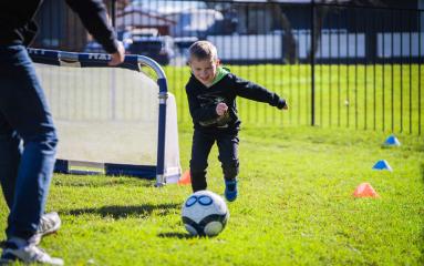 Young boy playing football