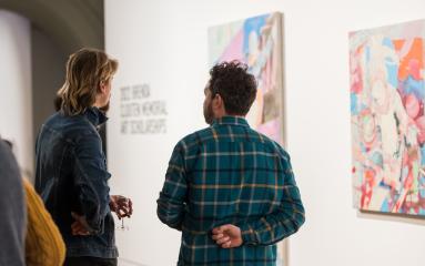 Two people talking and viewing artworks at the 2022 Brenda Clouten Memorial Exhibition at Maitland Regional Art Gallery