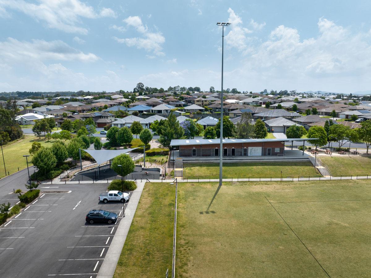 Aerial view of carpark, playground and amenities building 