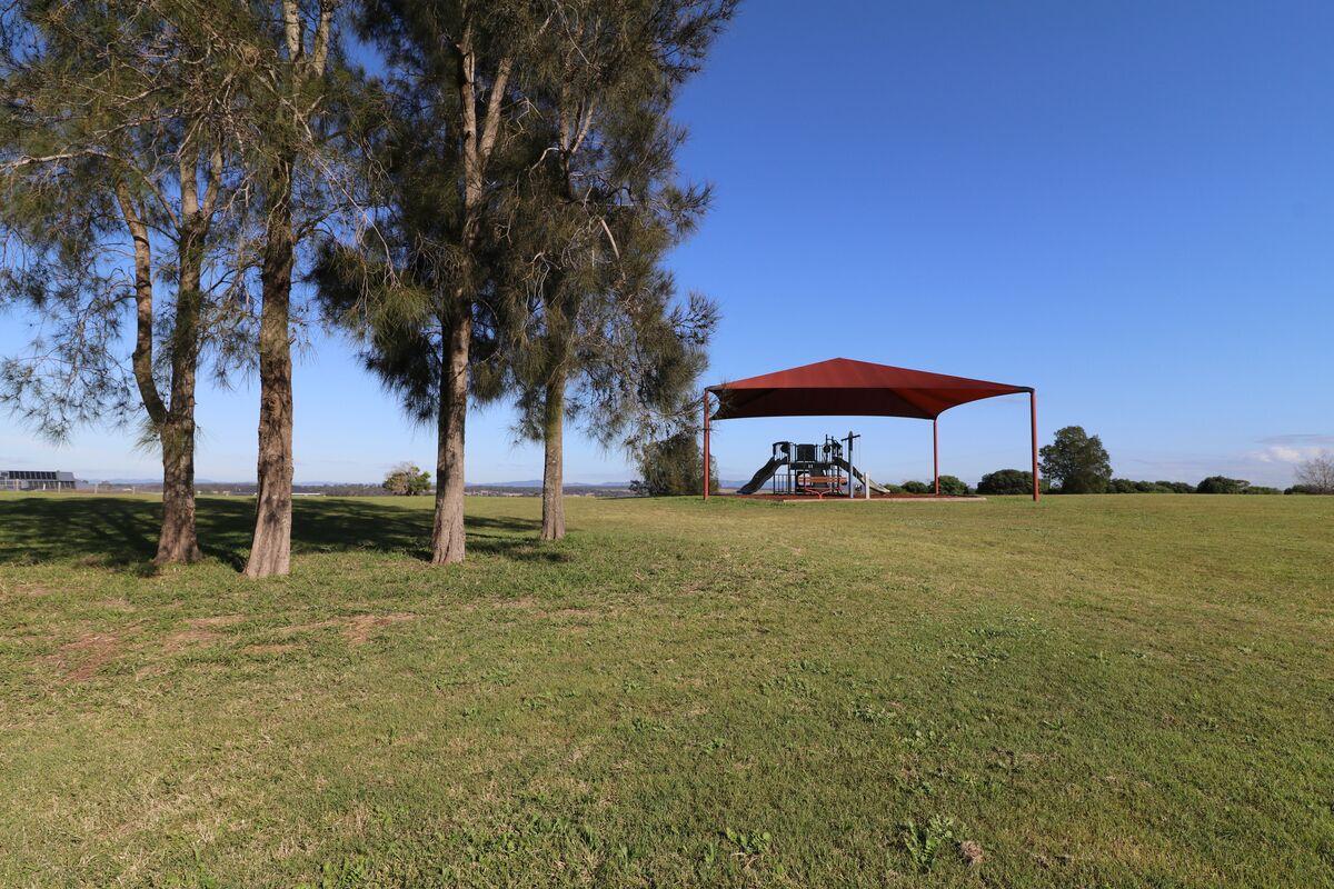 Grass area, playground and shade sail