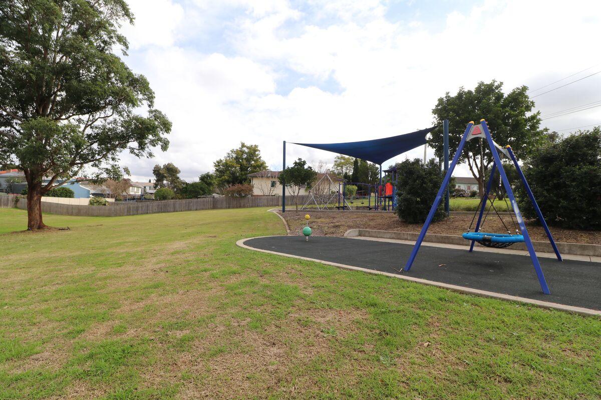 Grass area, playground and shade sail