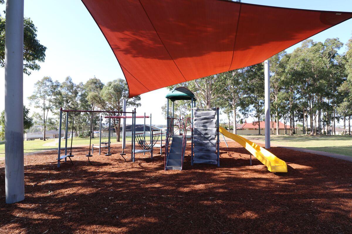 Playground and shade sail with slide