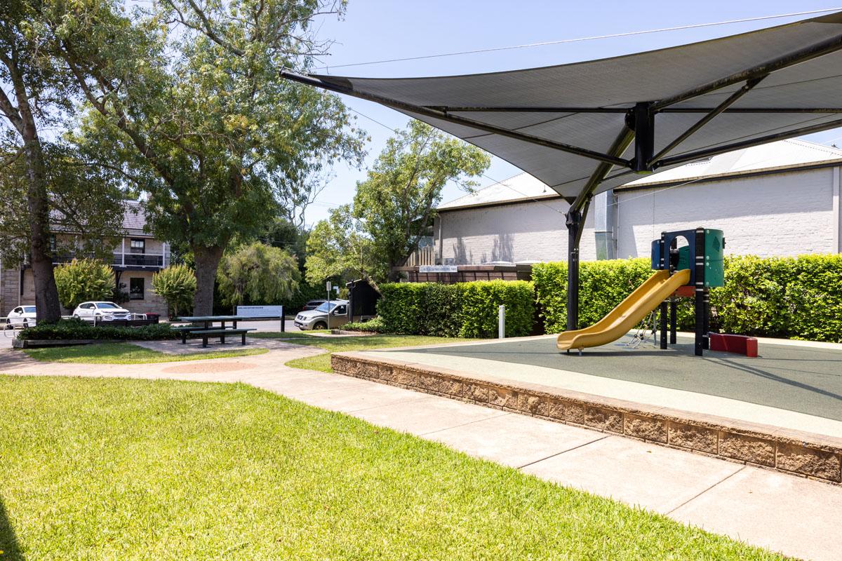 Grass area, shade sail and playground