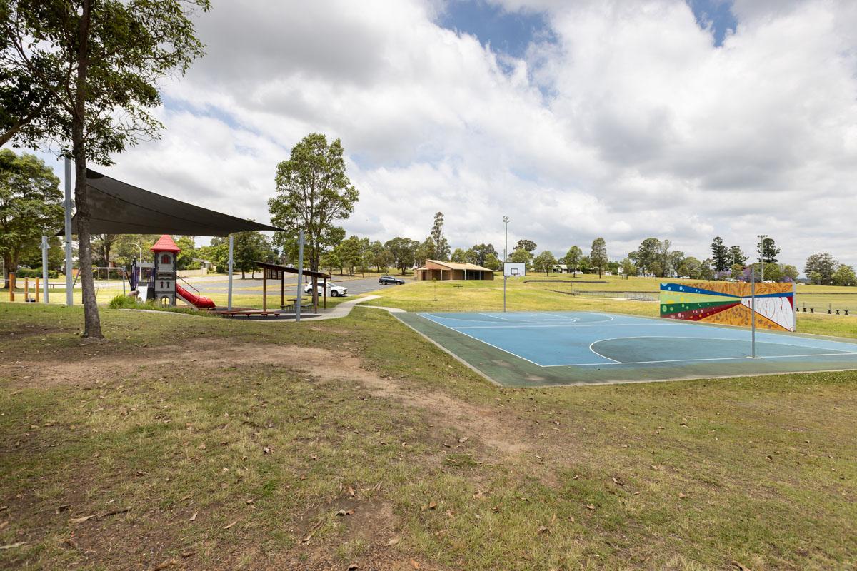 Shade sail, playground, basketball court and wall 