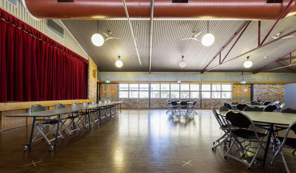 Hall with chairs in circle and main panel in front of stage