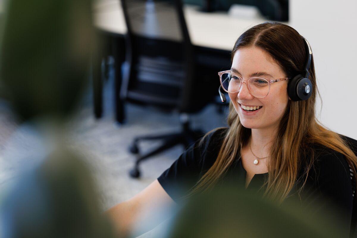 Woman with glasses talking on phone headset