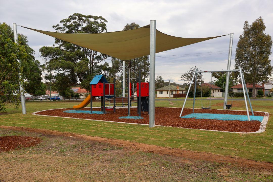 Shade sail covering play equipment